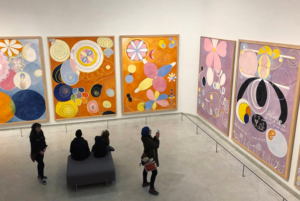 Caption: It is only in recent years that Hilma af Klint’s pioneering abstract work has received credit. This is a view of the popular exhibition at Guggenheim in 2018 (Ryan Dickey, CC BY 2.0)