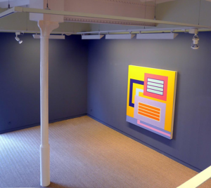 Caption: “Postmodern” artists like Peter Halley copied the visual language of modernist abstract art (in this case geometric abstraction) to comment on the nature of art and meaning itself. These blocks of colour actually represent “cells” and “conduits”. Image: Installation view of Peter Halley’s exhibition “Prison” at Galleria Senda, Barcelona in 2012. (CC BY-SA 4.0 image by Abcd09)